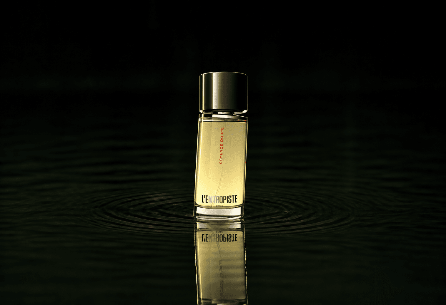 L'Entropiste Semence Douce fragrance bottle floating above dark water