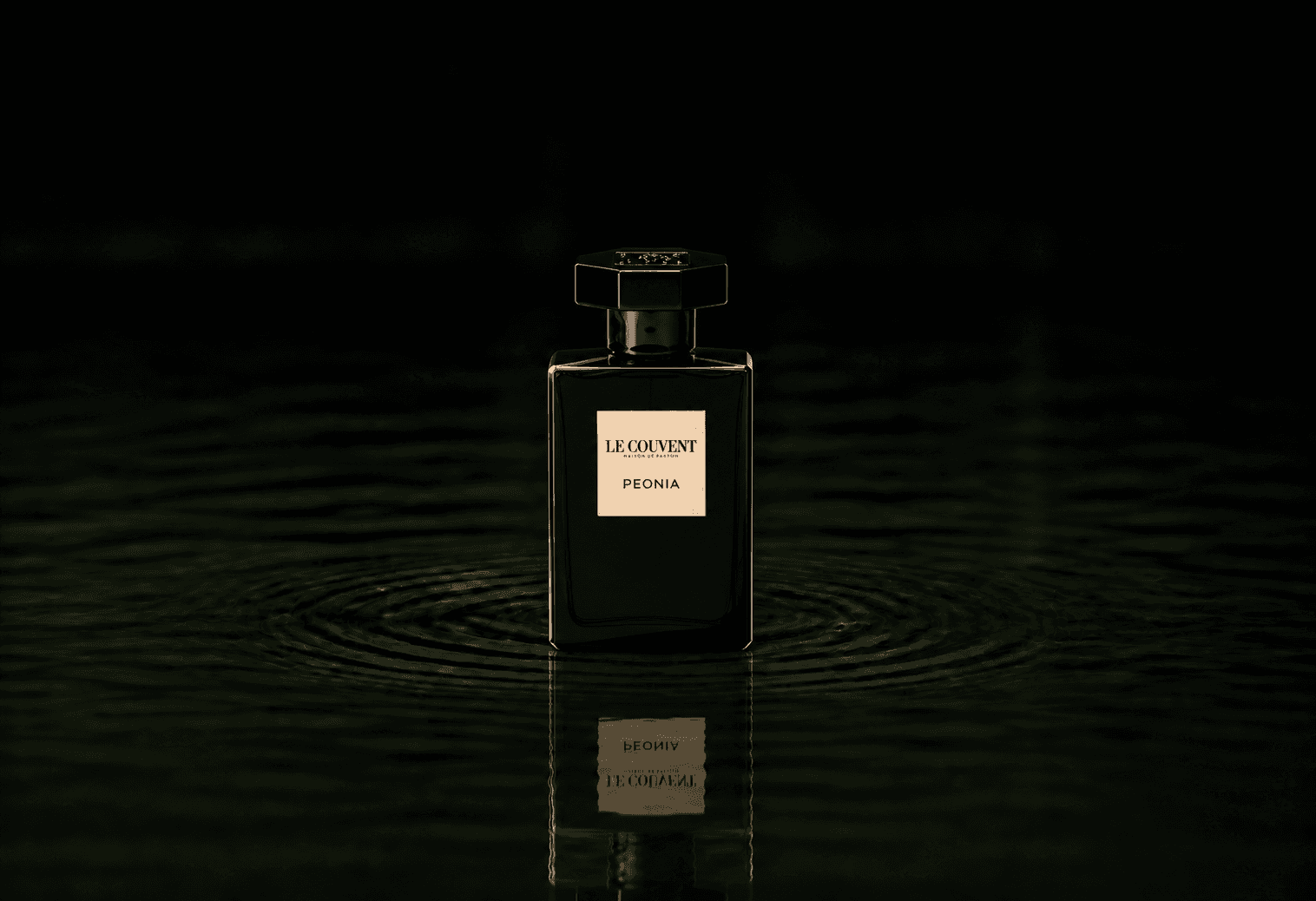 Le Couvent Maison Peonia Parfum fragrance bottle floating above dark water