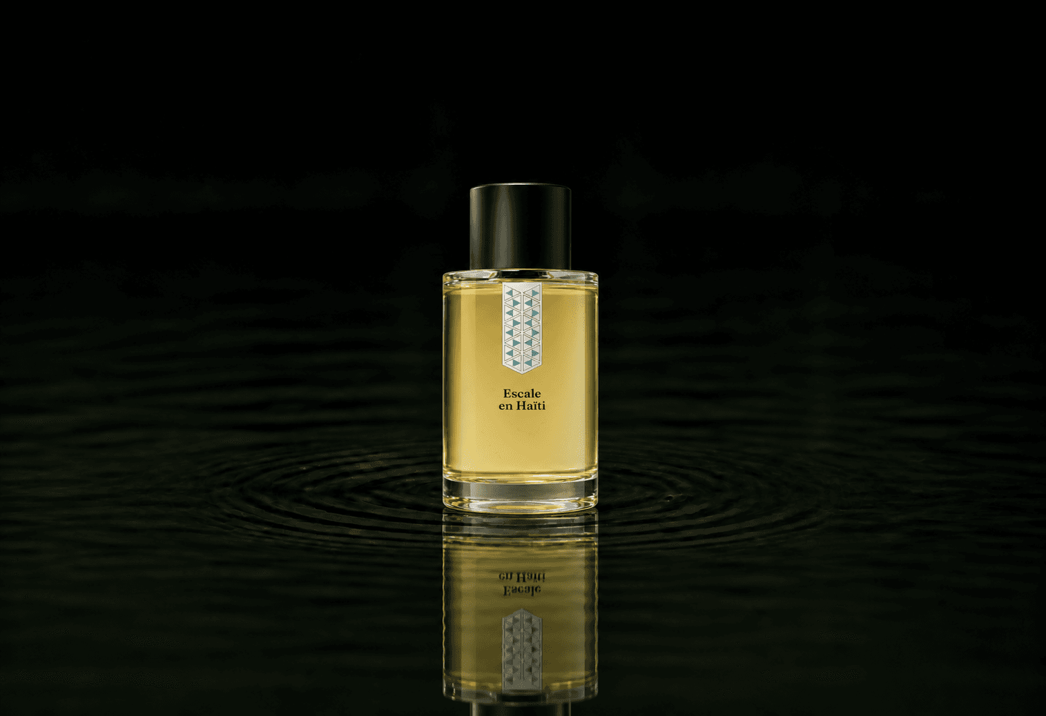 Les Indemodables Escale en Haiti Edc fragrance bottle floating above dark water