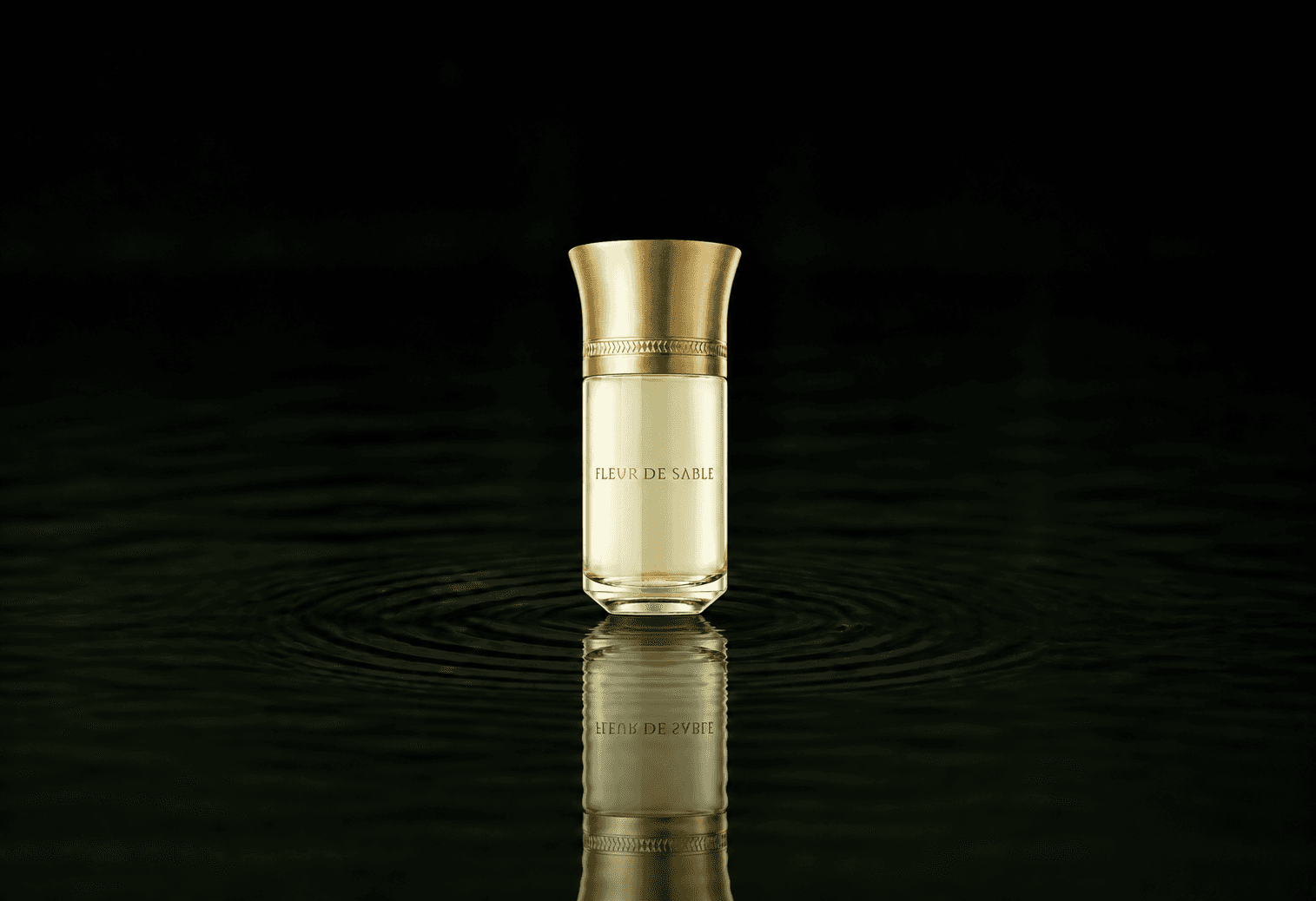 Liquides Imaginaires Fleur De Sable fragrance bottle floating above dark water