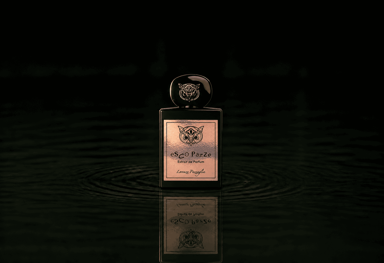 Lorenzo Pazzaglia Esco Pazzo fragrance bottle floating above dark water