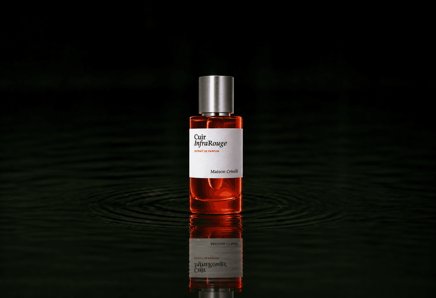 Maison Crivelli Cuir Infrarouge fragrance bottle floating above dark water