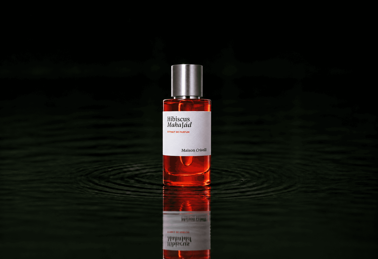 Maison Crivelli Hibiscus Mahajad fragrance bottle floating above dark water