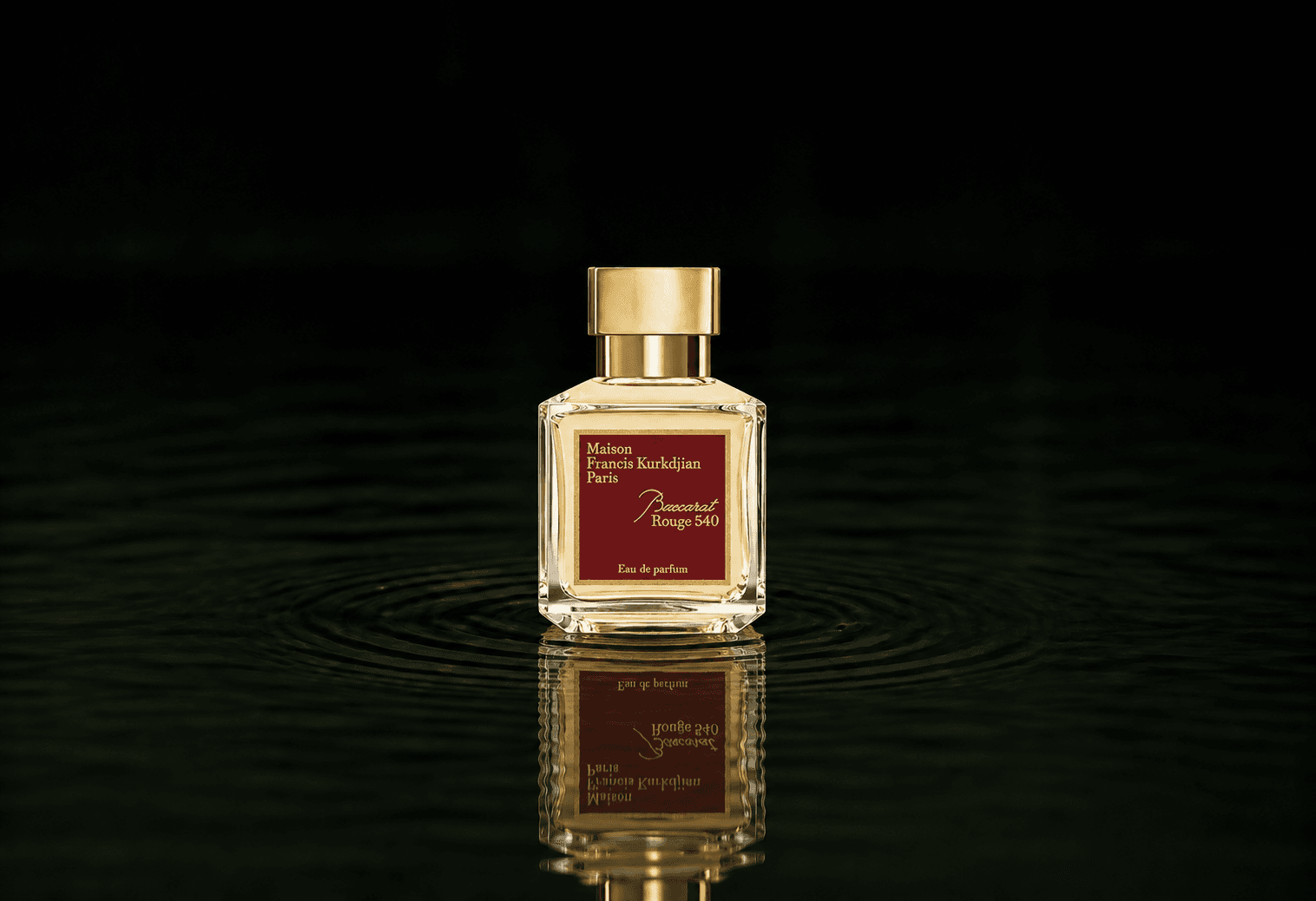 Maison Francis Kurkdjian Baccarat Rouge 540 fragrance bottle floating above dark water