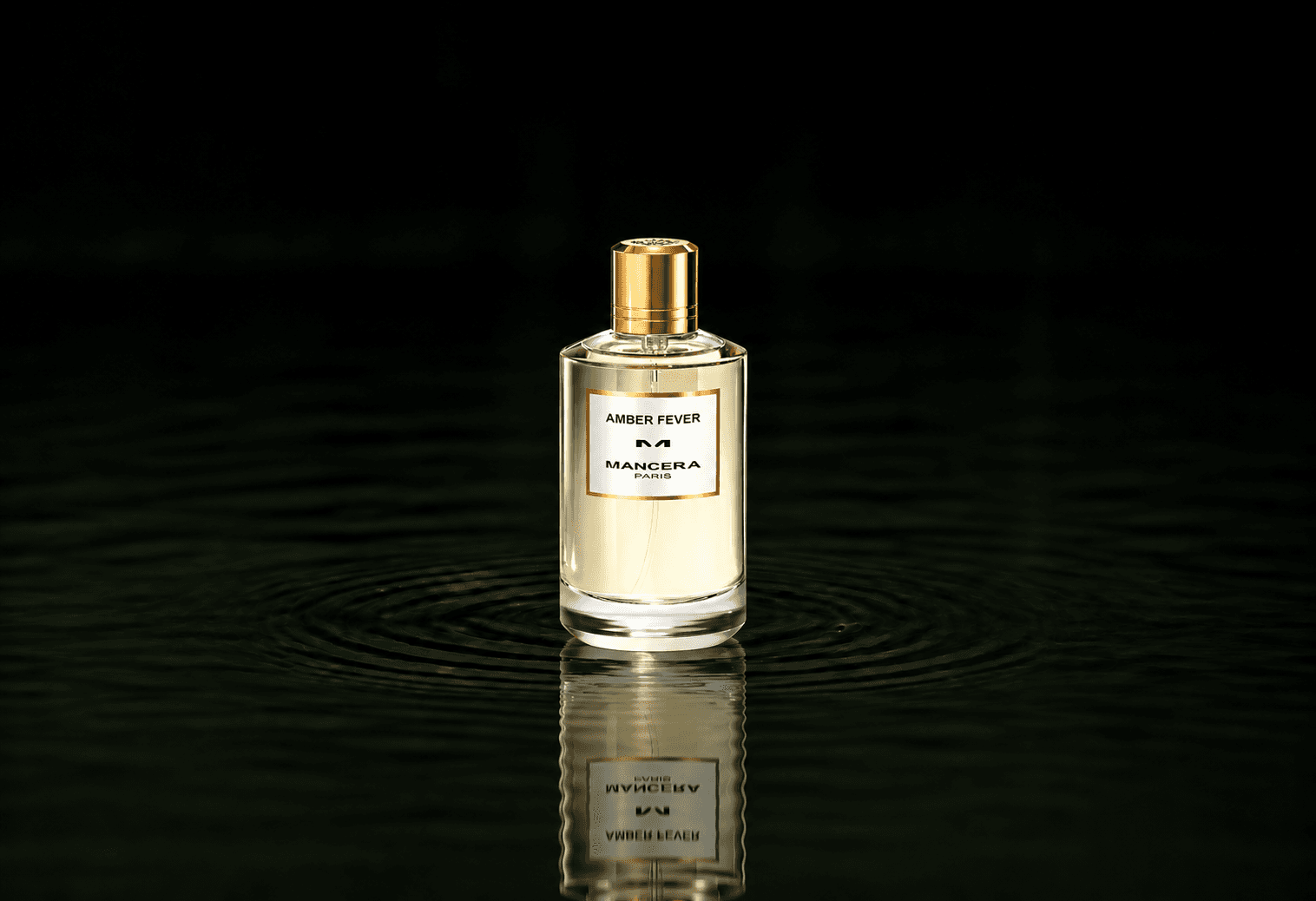 Mancera Amber Fever fragrance bottle floating above dark water