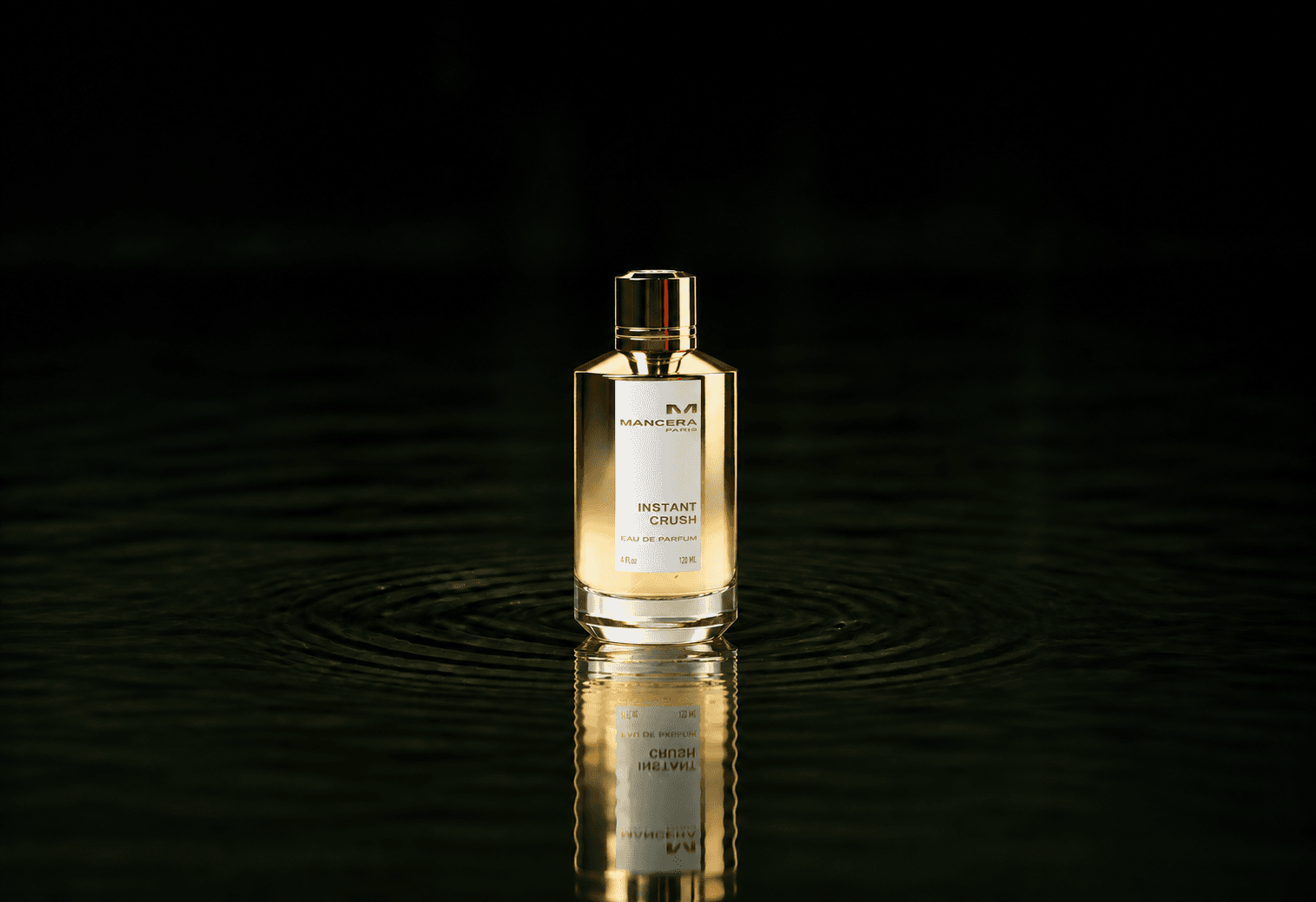 Mancera Instant Crush fragrance bottle floating above dark water