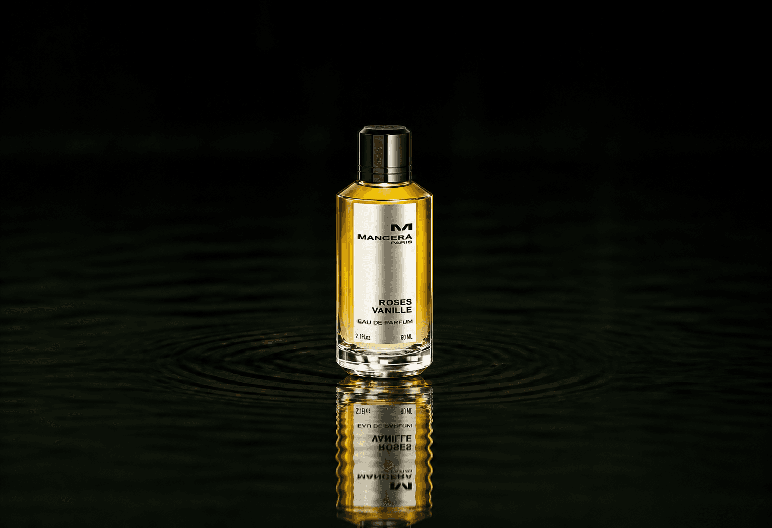 Mancera Roses Vanille fragrance bottle floating above dark water