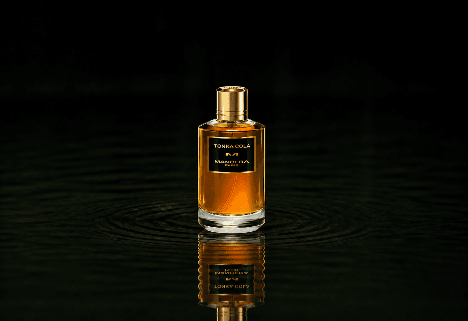 Mancera Tonka Cola fragrance bottle floating above dark water