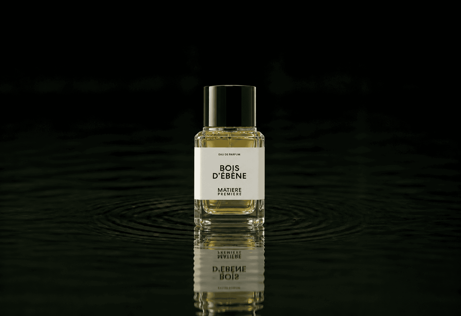 Matiere Premiere Bois d'Ebene fragrance bottle floating above dark water