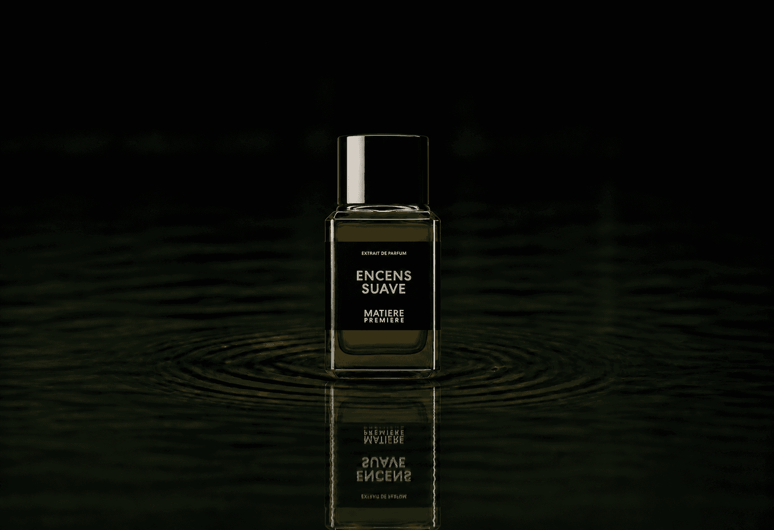 Matiere Premiere Encens Suave Extrait fragrance bottle floating above dark water