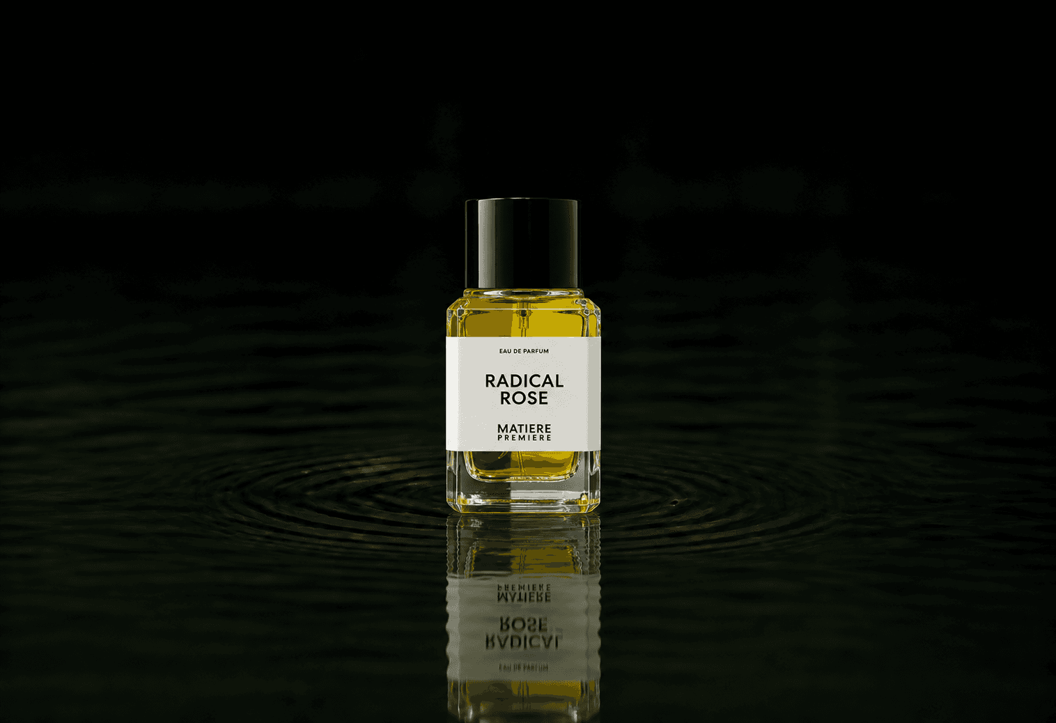 Matiere Premiere Radical Rose fragrance bottle floating above dark water