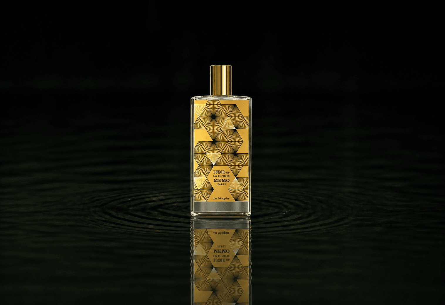Memo Paris Les Echappées - Luxor Oud fragrance bottle floating above dark water