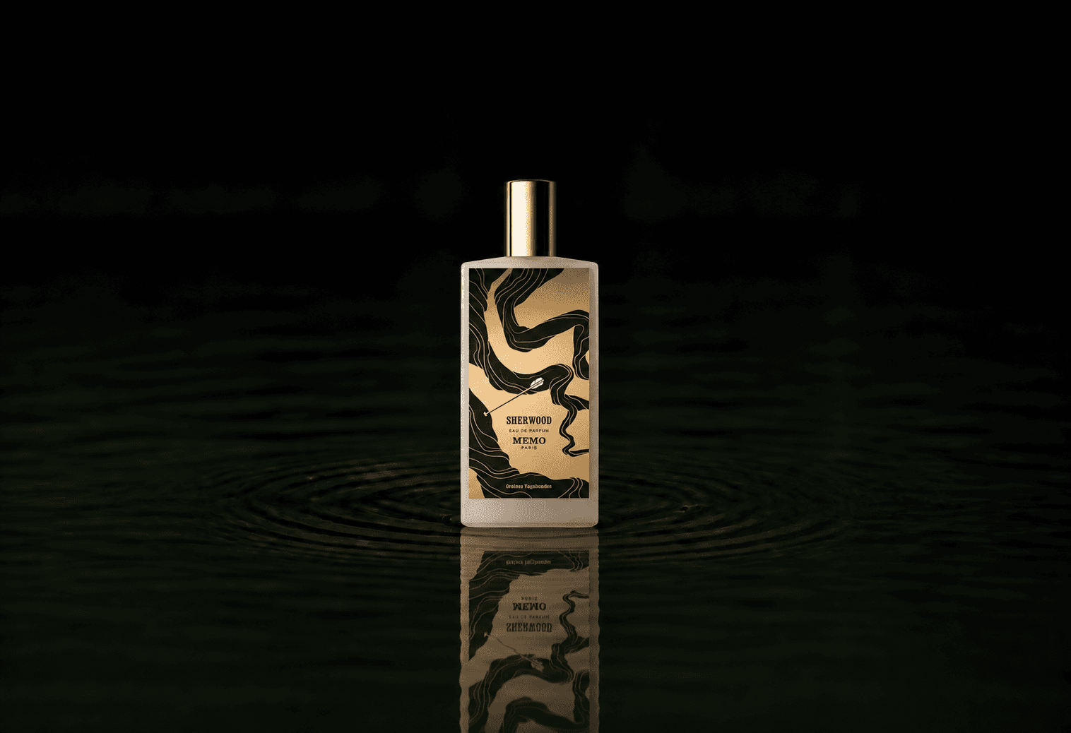 Memo Paris MEMO - Sherwood fragrance bottle floating above dark water