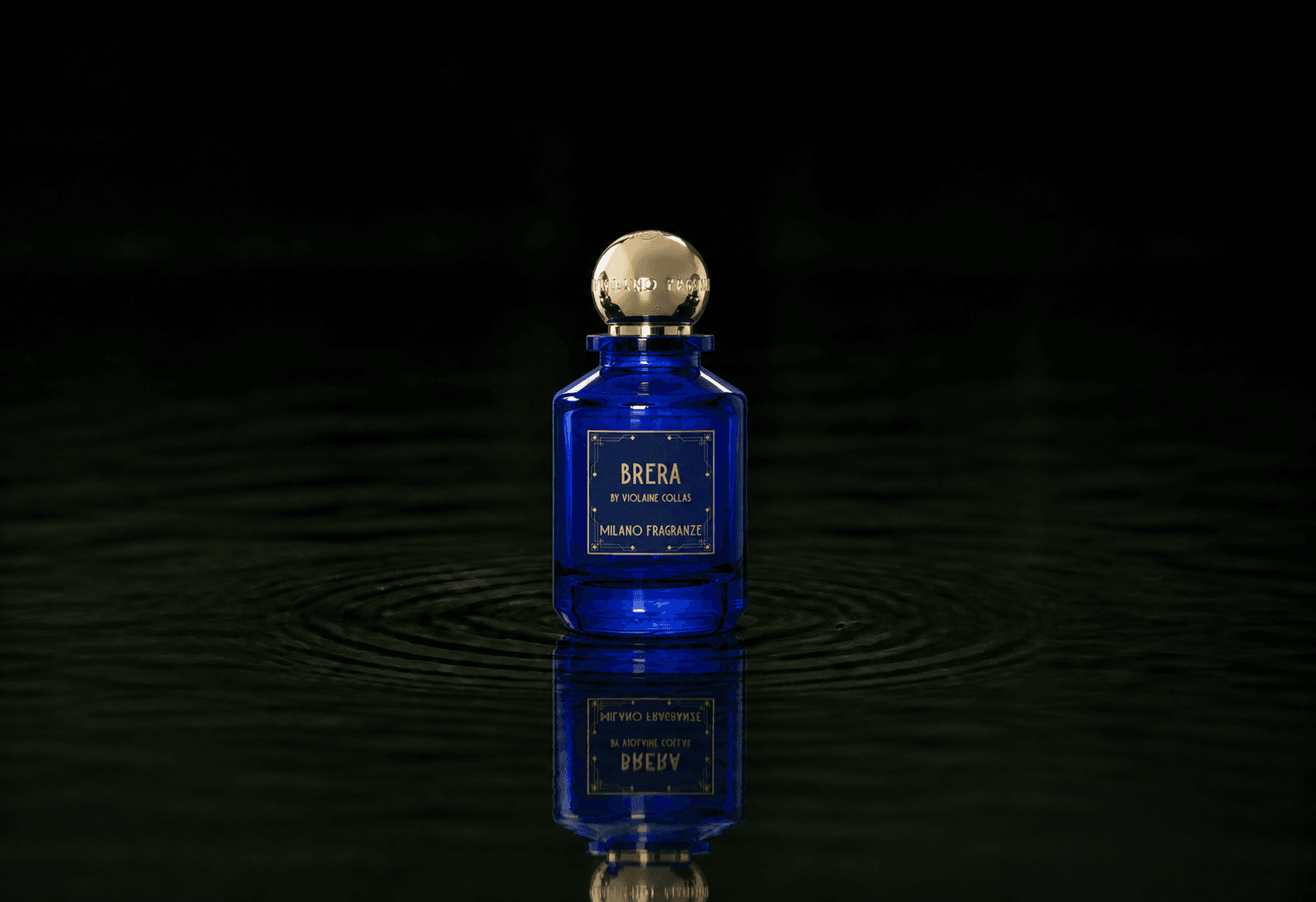 Milano Fragranze Brera fragrance bottle floating above dark water