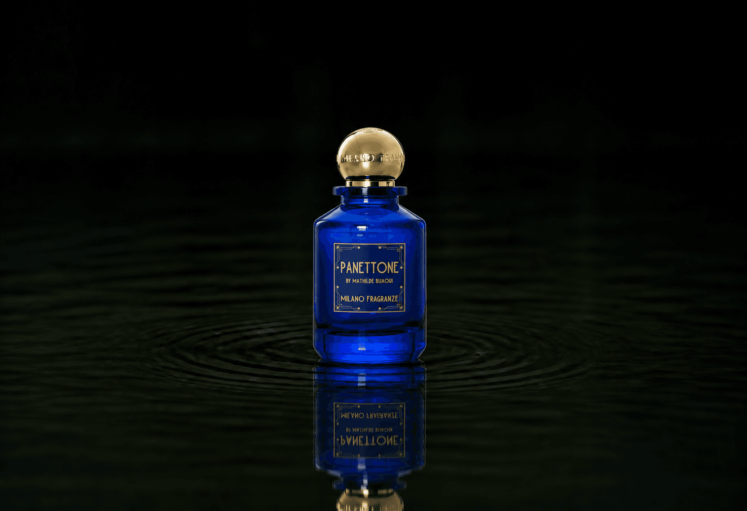 Milano Fragranze Panettone fragrance bottle floating above dark water