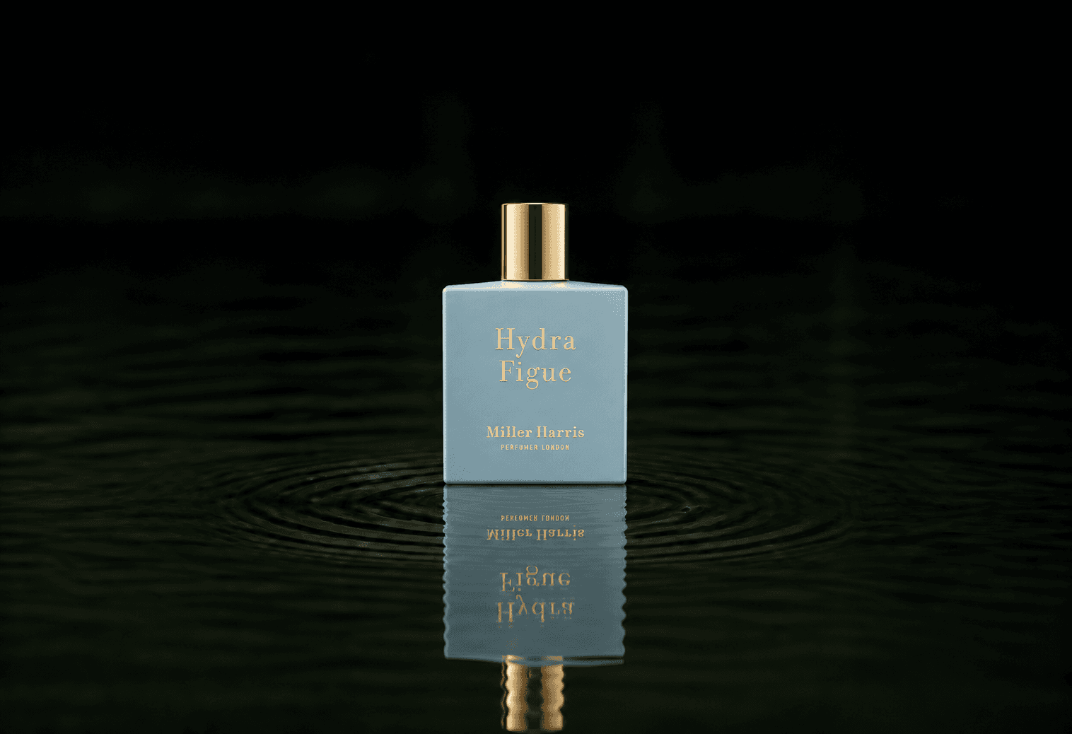 Miller Harris Hydra Figue fragrance bottle floating above dark water
