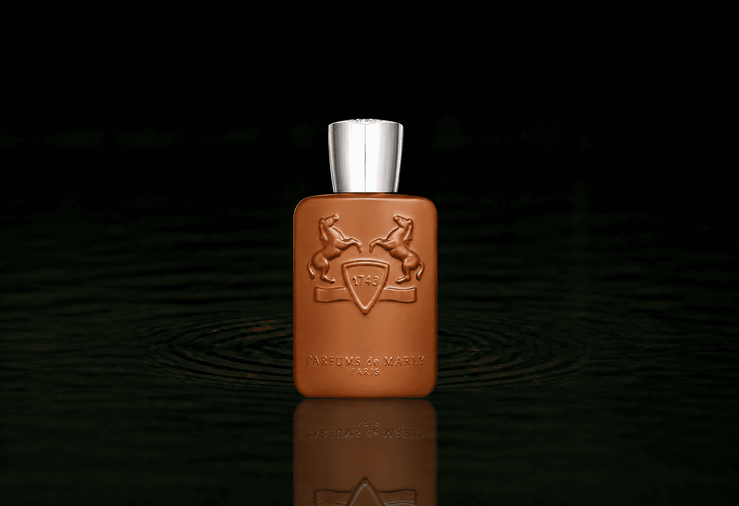 Parfums de Marly Althair fragrance bottle floating above dark water