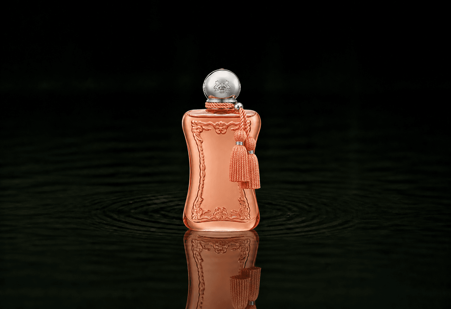 Parfums de Marly Athenais fragrance bottle floating above dark water