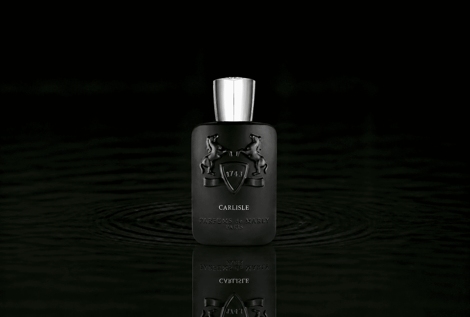 Parfums de Marly Carlisle fragrance bottle floating above dark water
