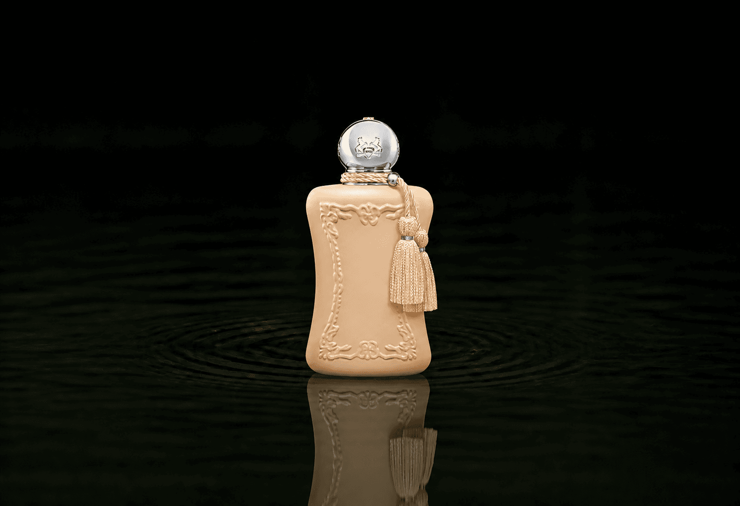 Parfums de Marly Cassili fragrance bottle floating above dark water