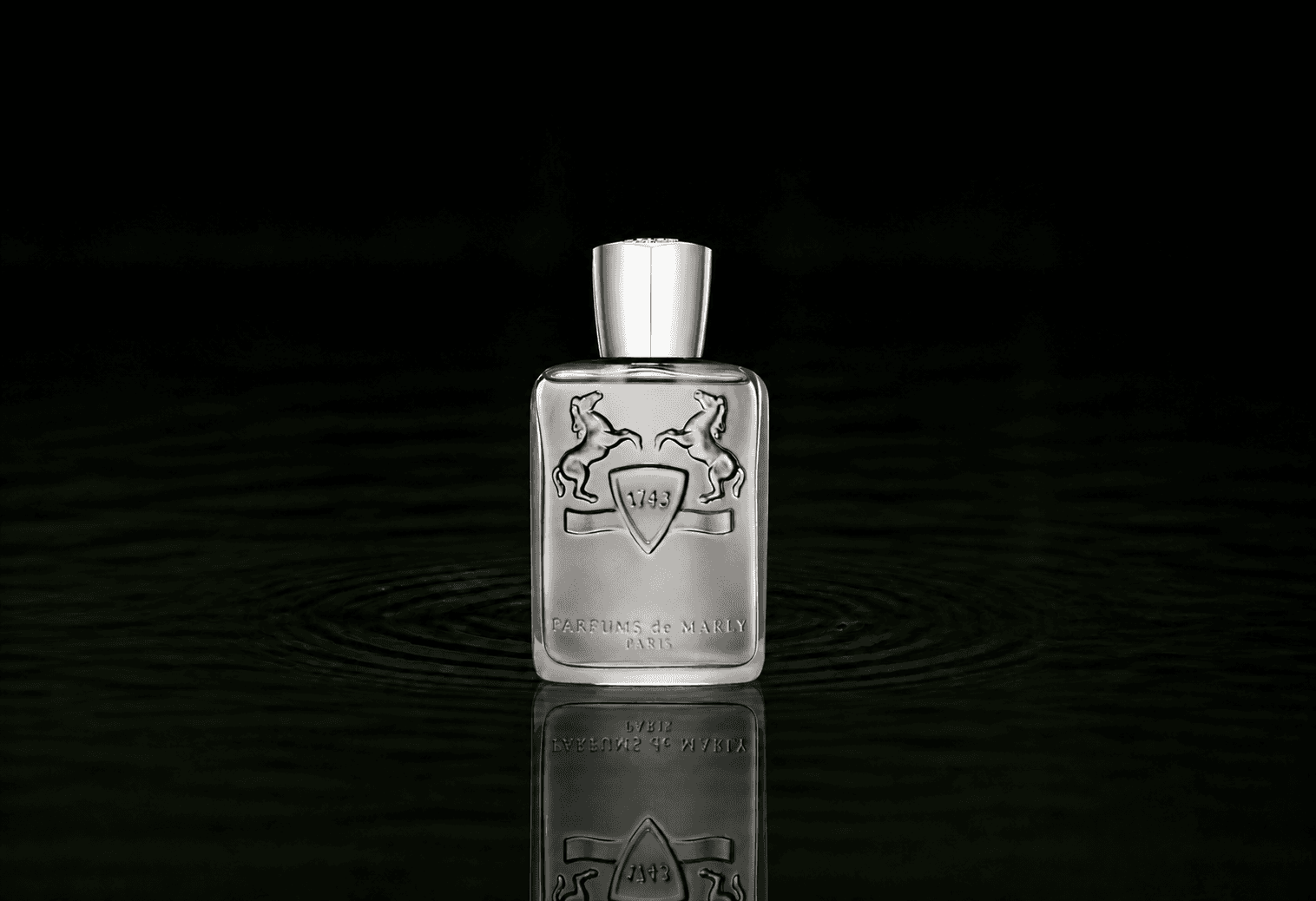 Parfums de Marly Castley fragrance bottle floating above dark water
