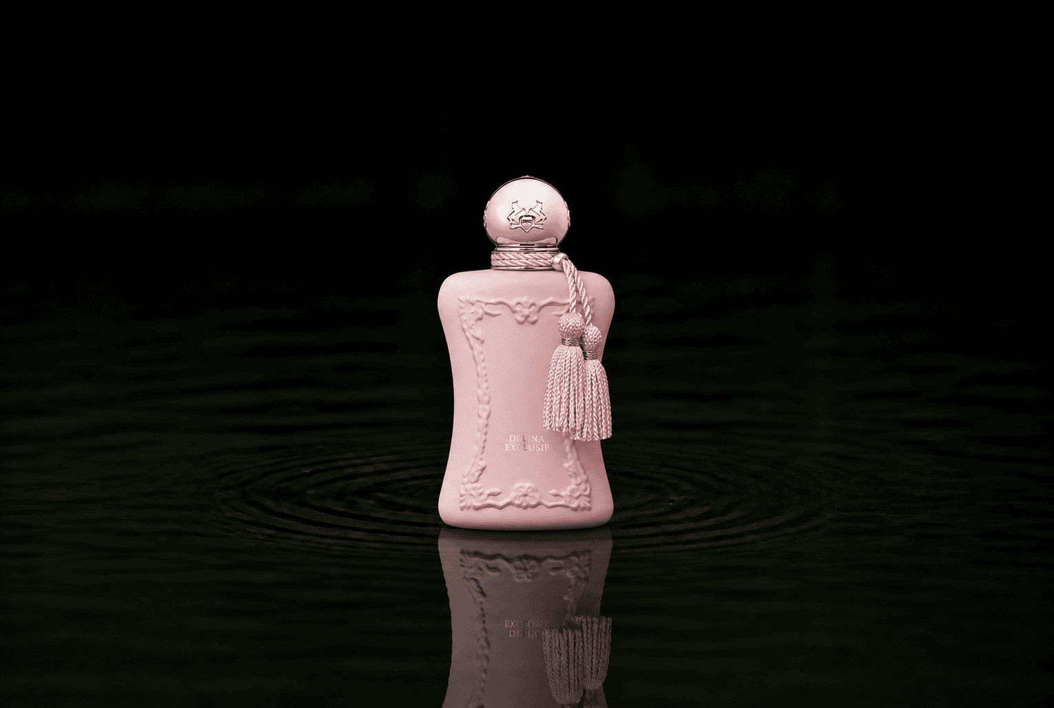 Parfums de Marly Delina Exclusif fragrance bottle floating above dark water