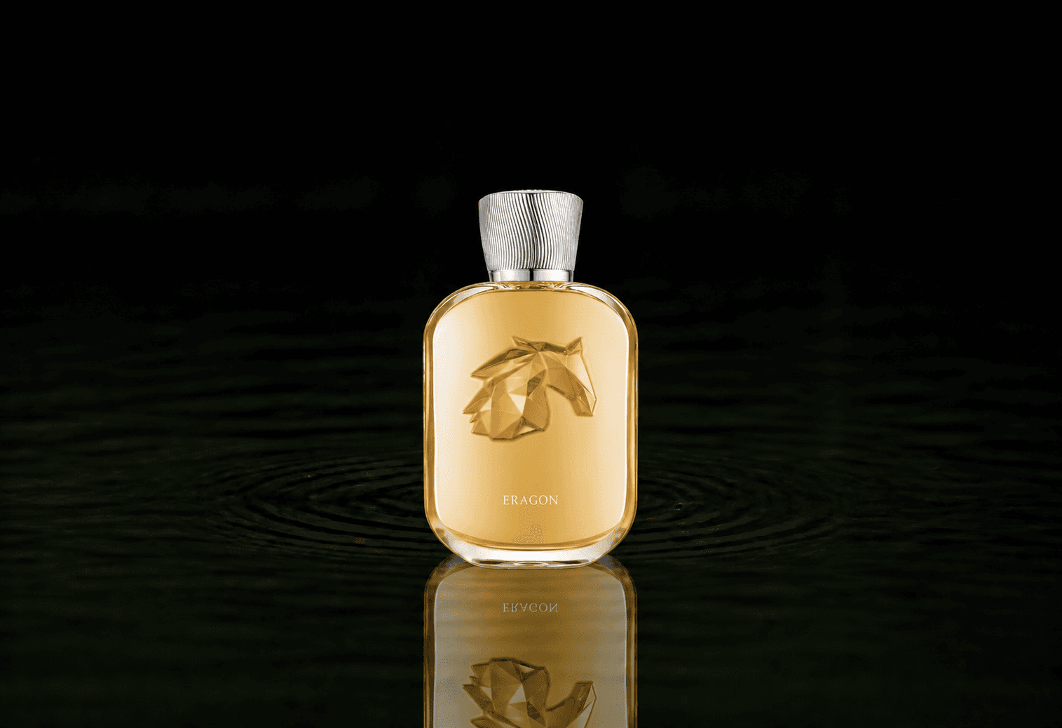 Parfums de Marly Eragon fragrance bottle floating above dark water