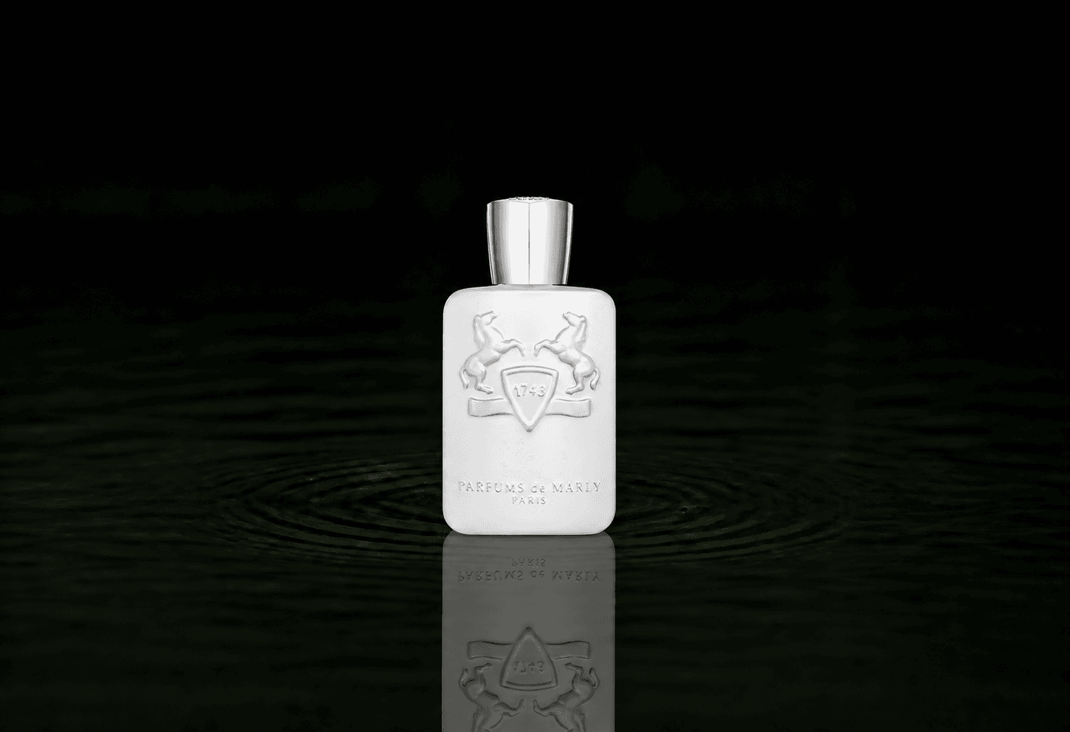 Parfums de Marly Galloway fragrance bottle floating above dark water
