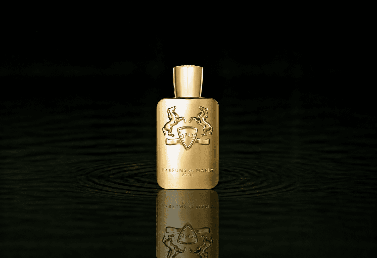 Parfums de Marly Godolphin fragrance bottle floating above dark water