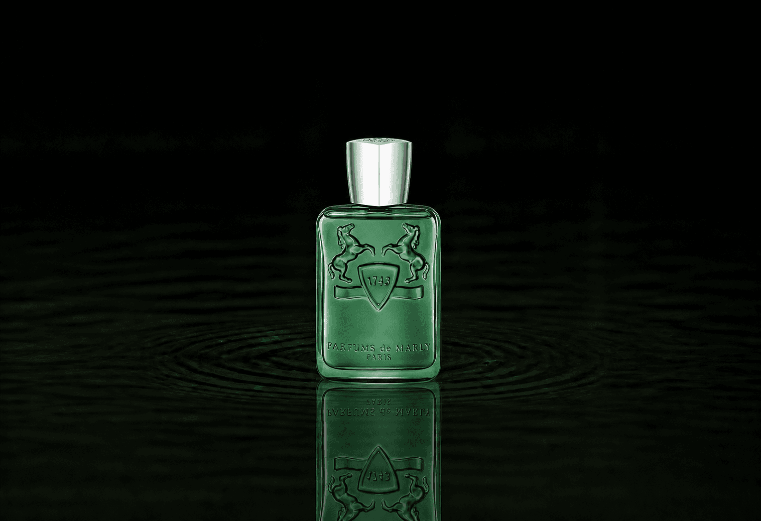 Parfums de Marly Greenley fragrance bottle floating above dark water
