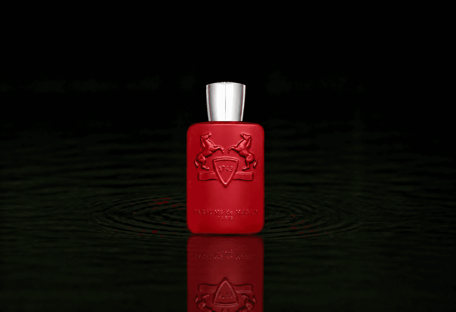 Parfums de Marly Kalan fragrance bottle floating above dark water