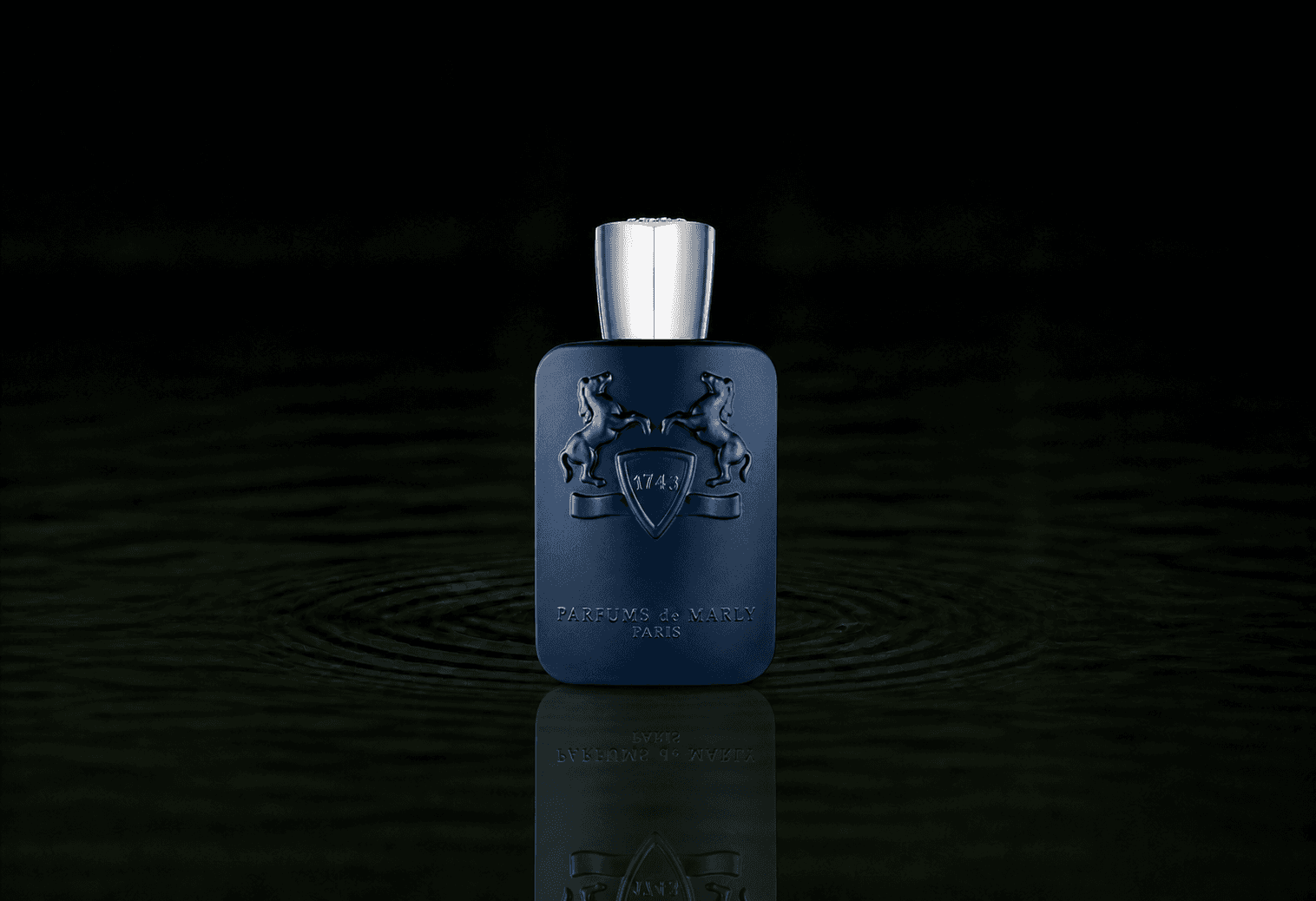 Parfums de Marly Layton fragrance bottle floating above dark water