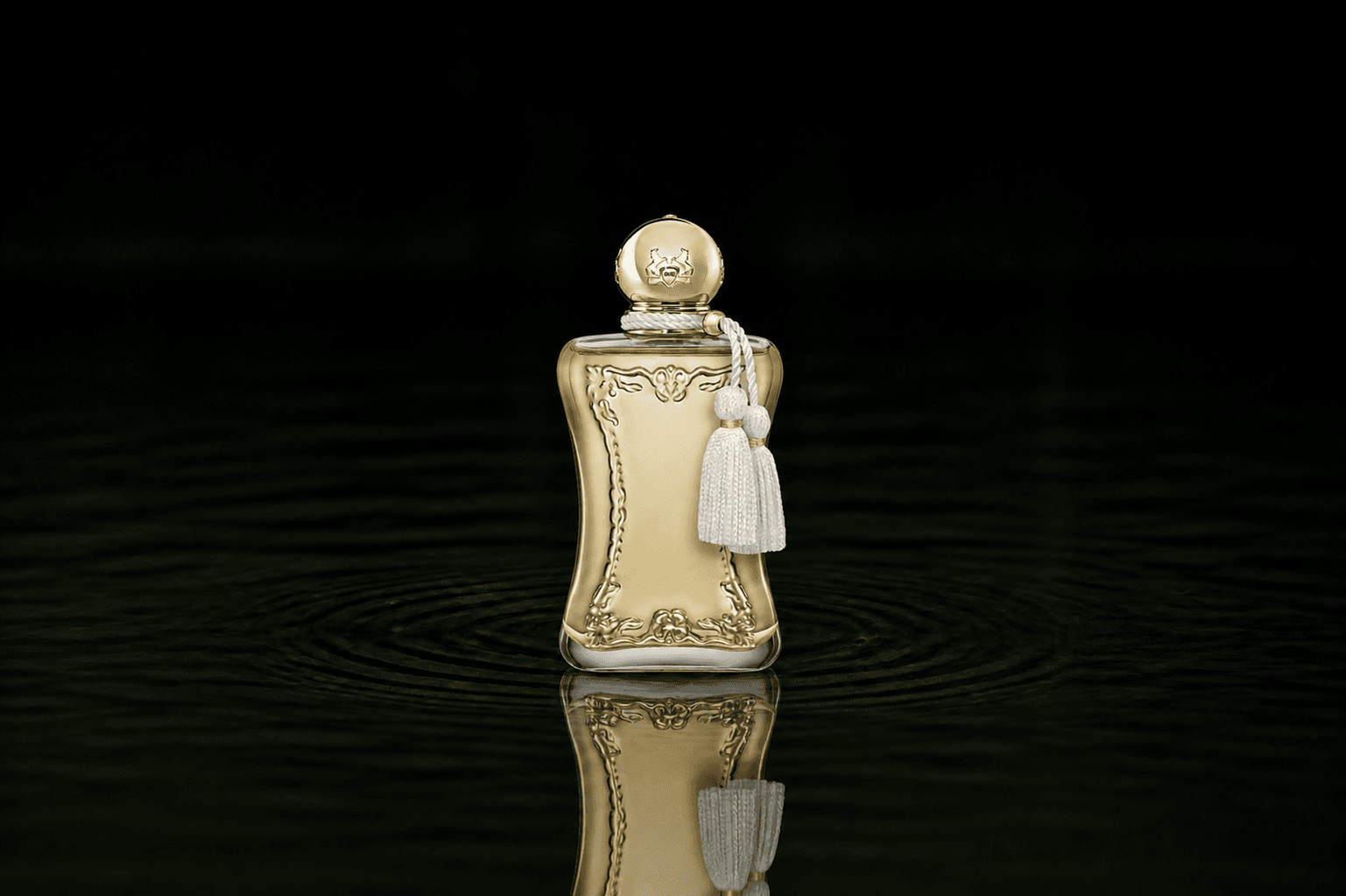 Parfums de Marly Meliora fragrance bottle floating above dark water