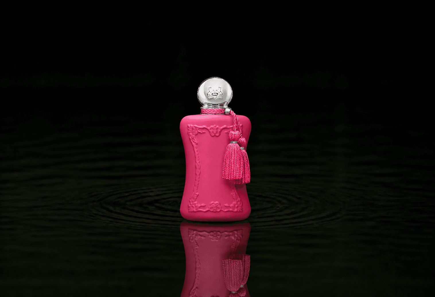 Parfums de Marly Oriana fragrance bottle floating above dark water