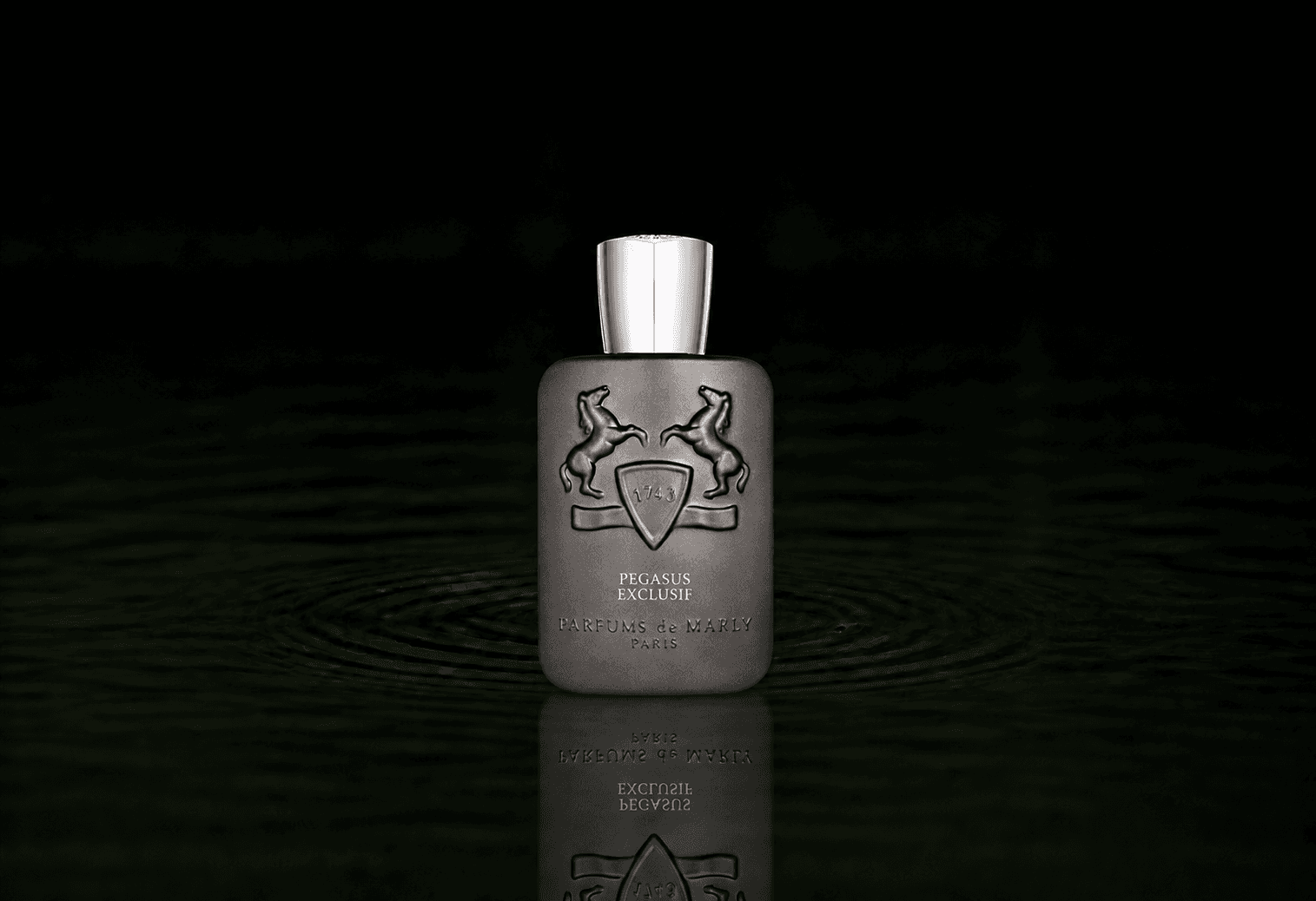 Parfums de Marly Pegasus Exclusif fragrance bottle floating above dark water