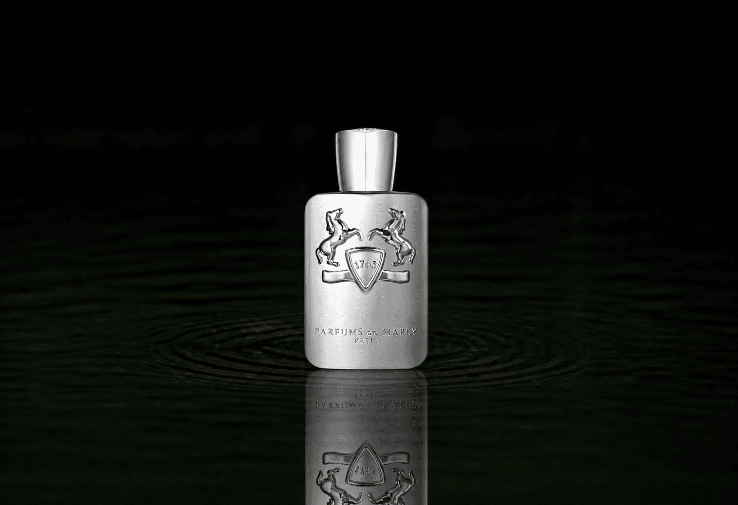Parfums de Marly Pegasus fragrance bottle floating above dark water