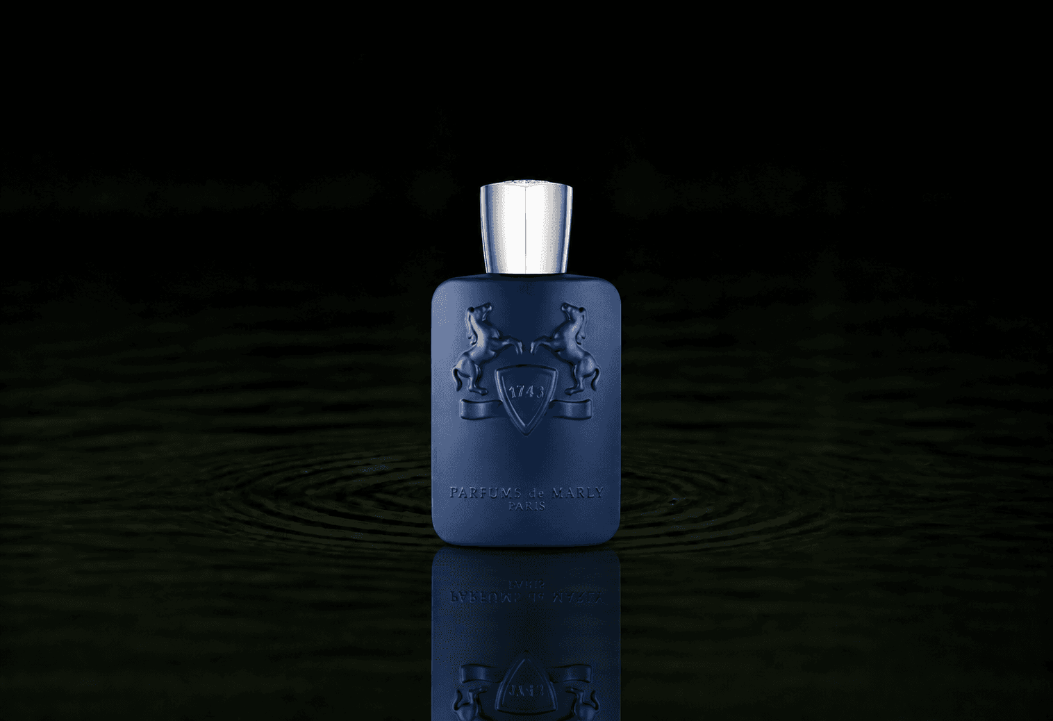 Parfums de Marly Percival fragrance bottle floating above dark water
