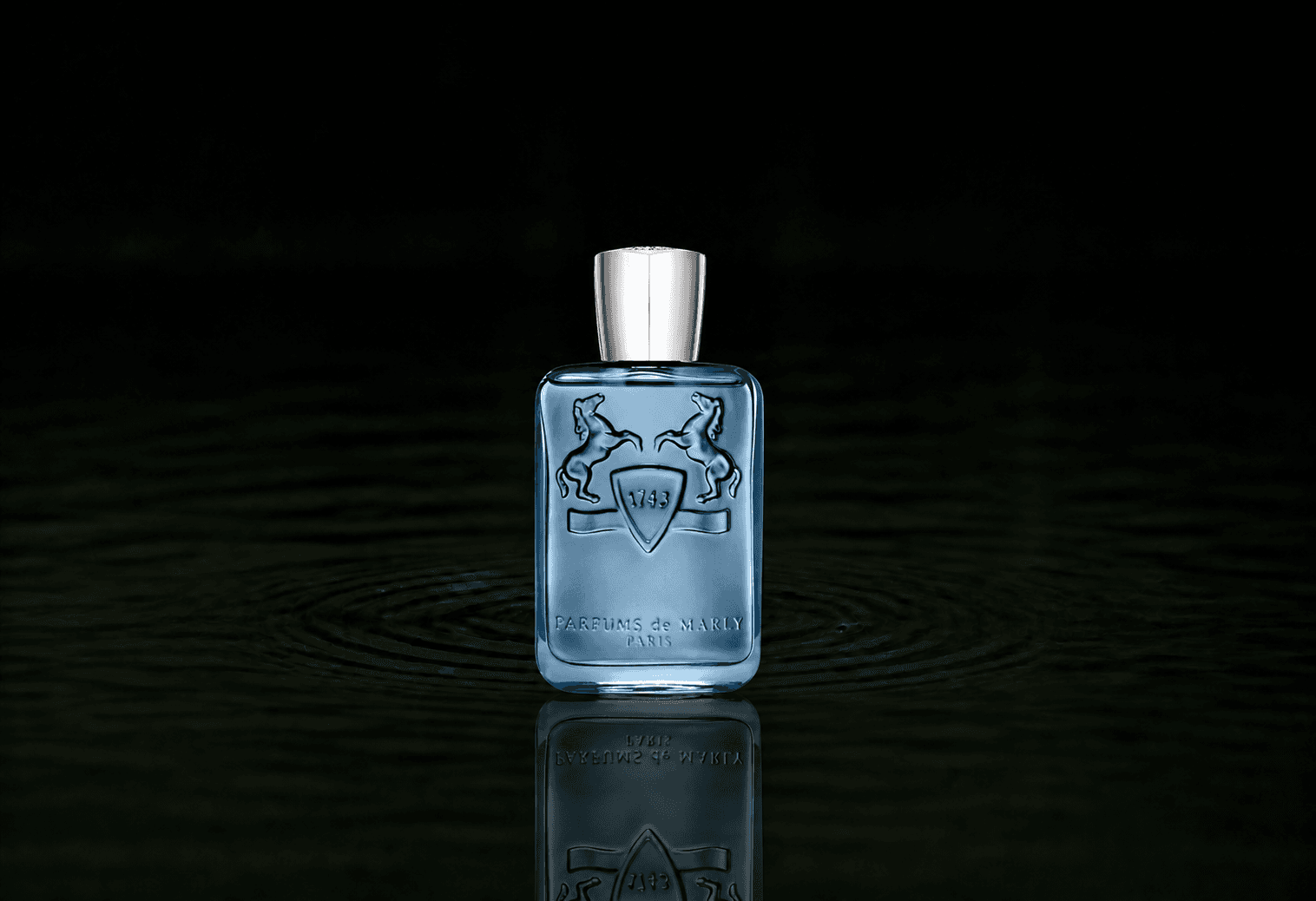 Parfums de Marly Sedley fragrance bottle floating above dark water