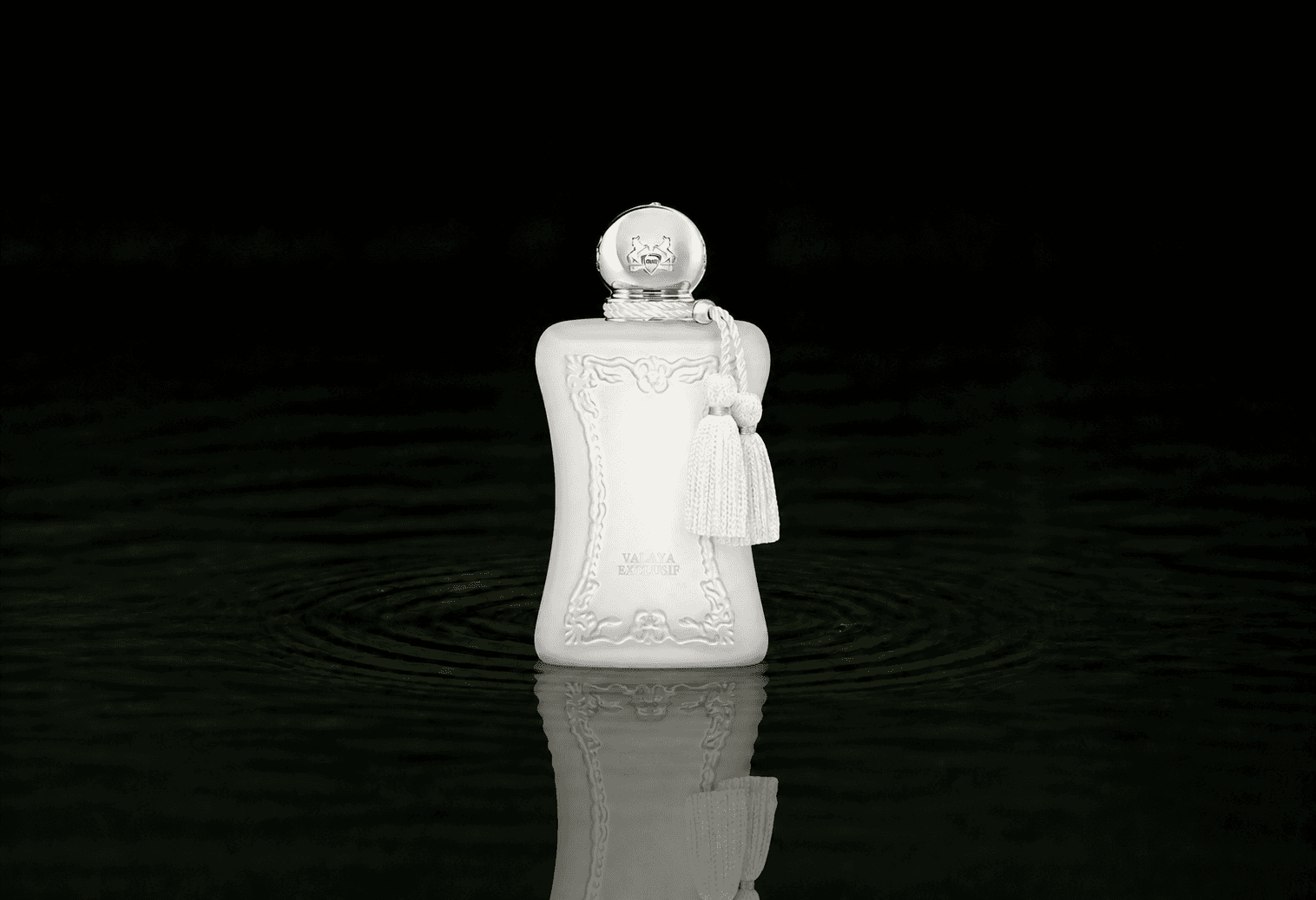Parfums de Marly Valaya Exclusif fragrance bottle floating above dark water