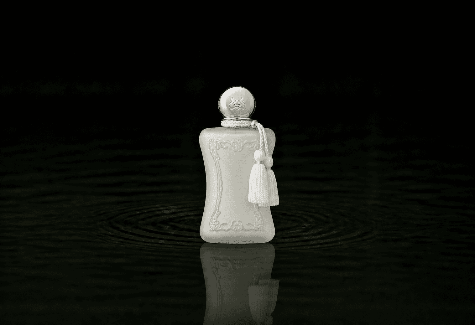 Parfums de Marly Valaya fragrance bottle floating above dark water