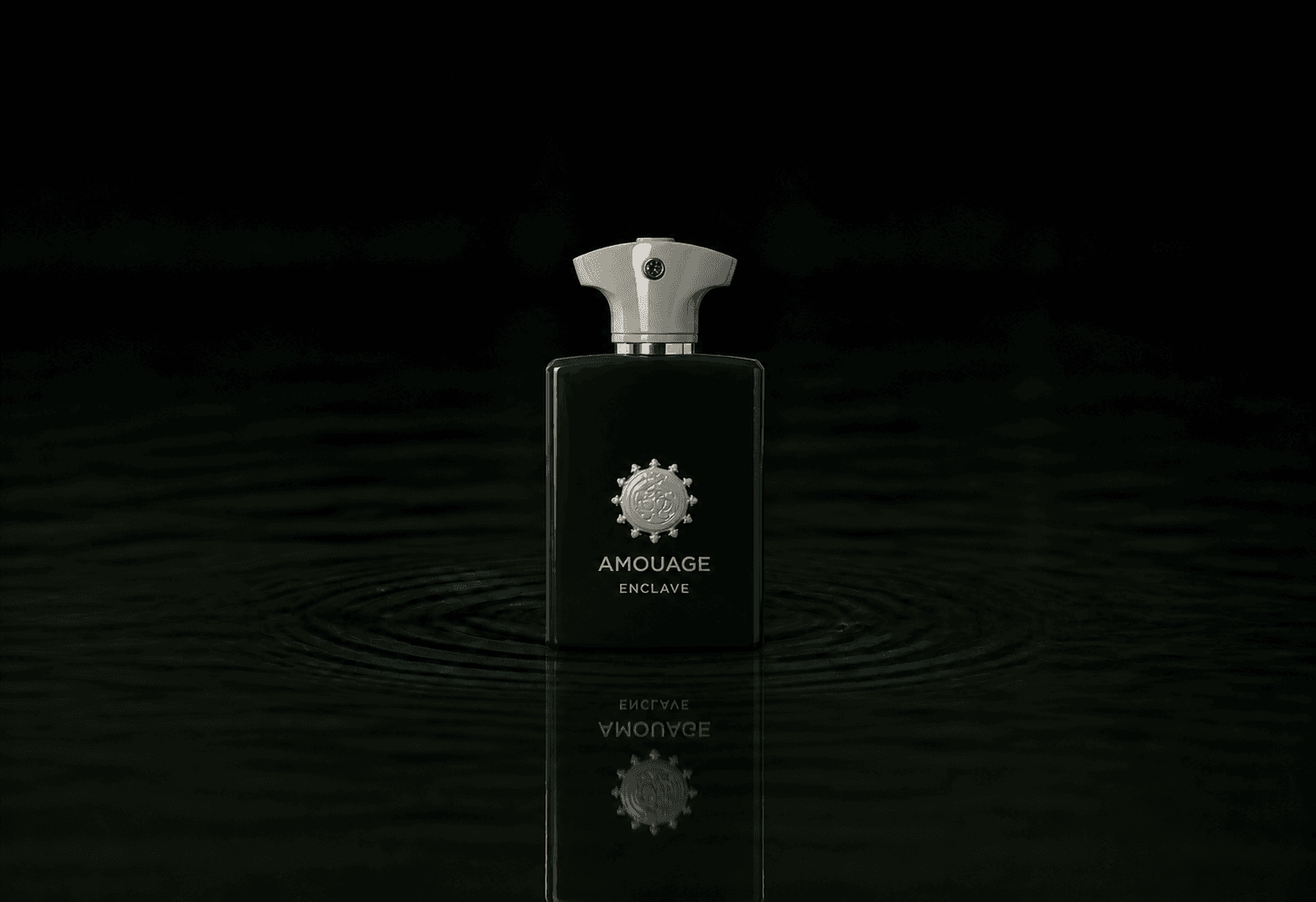 Amouage Enclave Man fragrance bottle floating above dark water