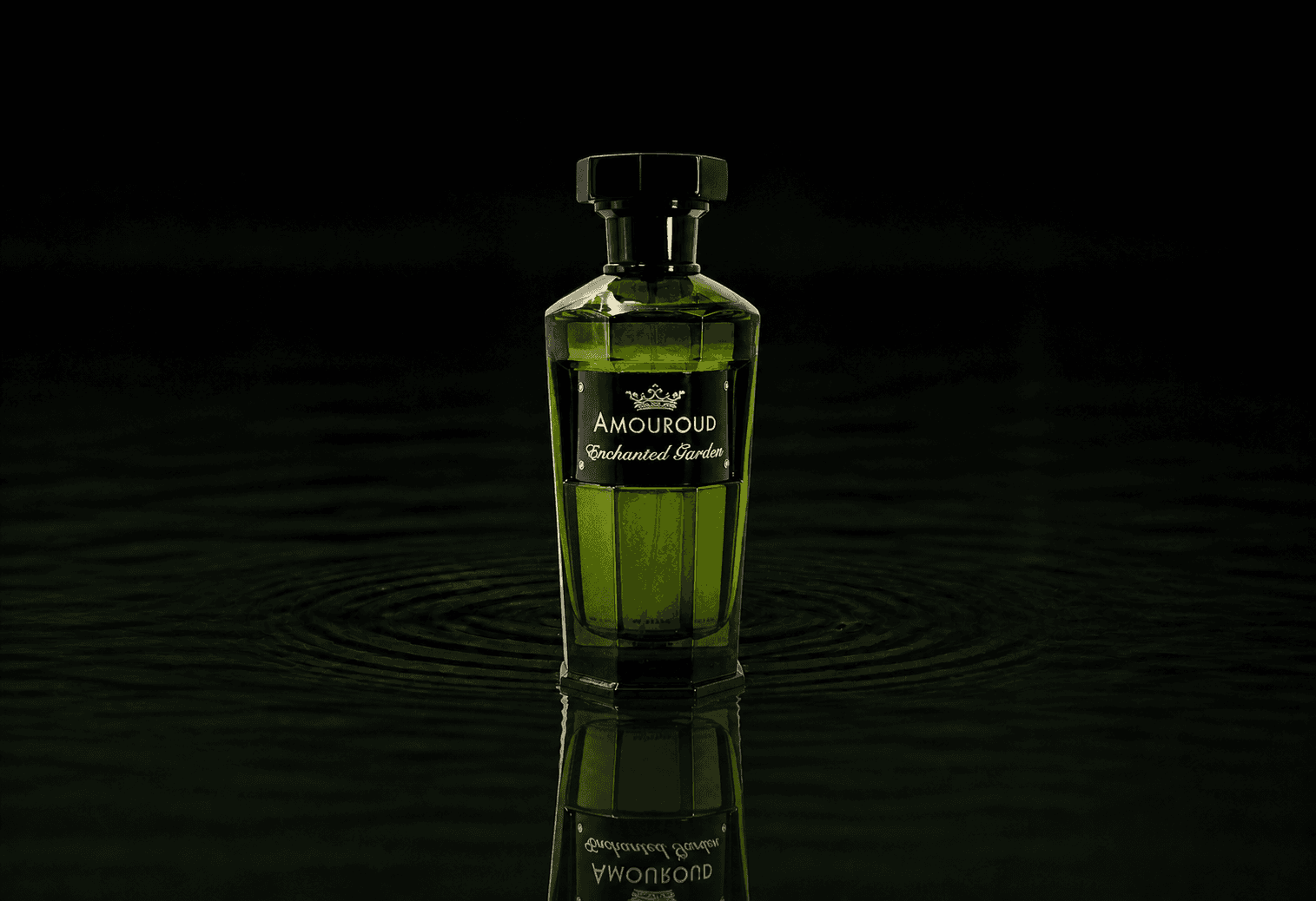 Amouroud Enchanted Garden fragrance bottle floating above dark water