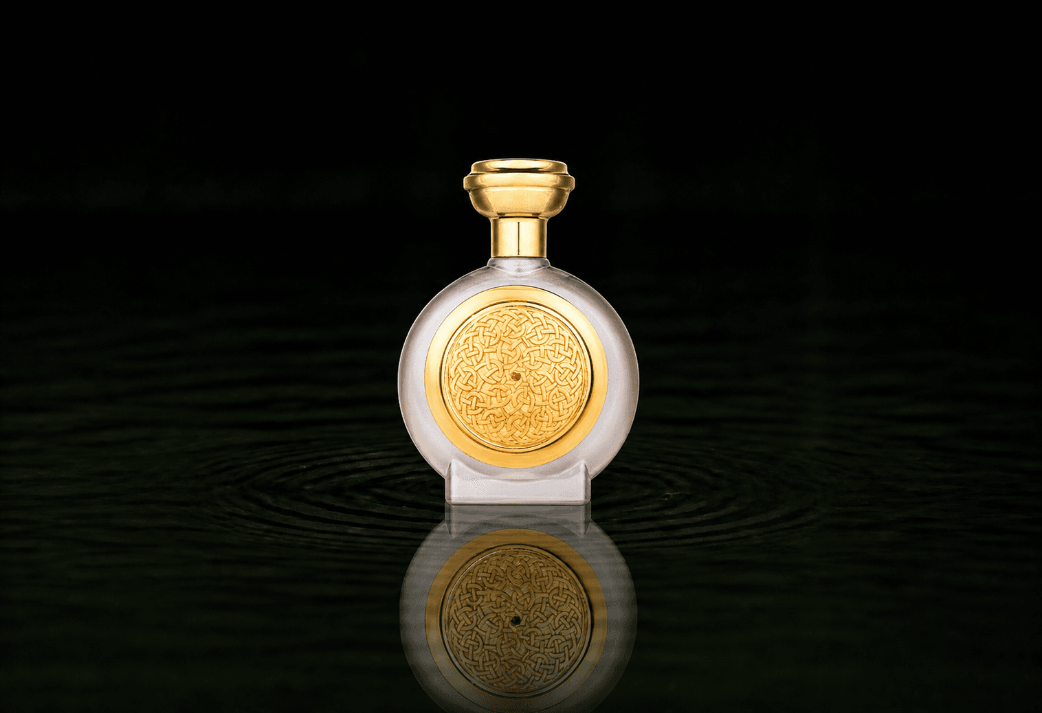 Boadicea The Victorious Amber Sapphire parfum fragrance bottle floating above dark water