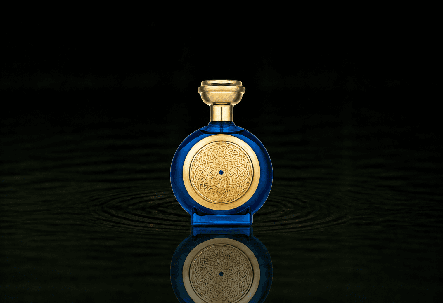 Boadicea The Victorious Blue Sapphire parfum fragrance bottle floating above dark water