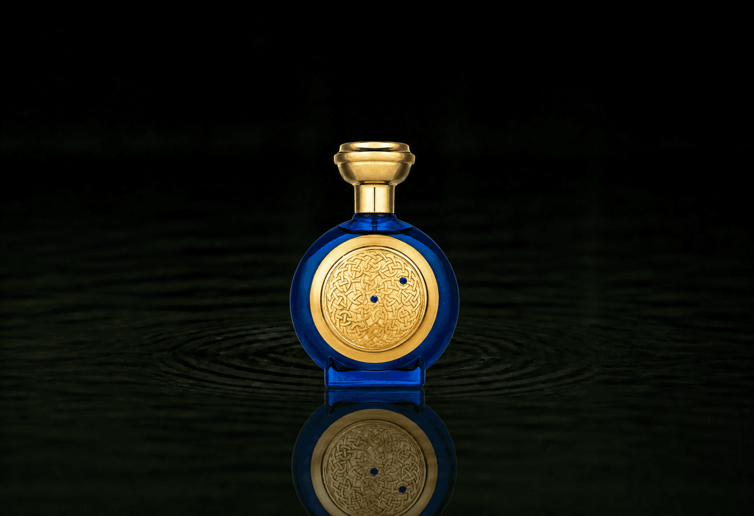 Boadicea The Victorious Blue Sapphire Supercharged fragrance bottle floating above dark water