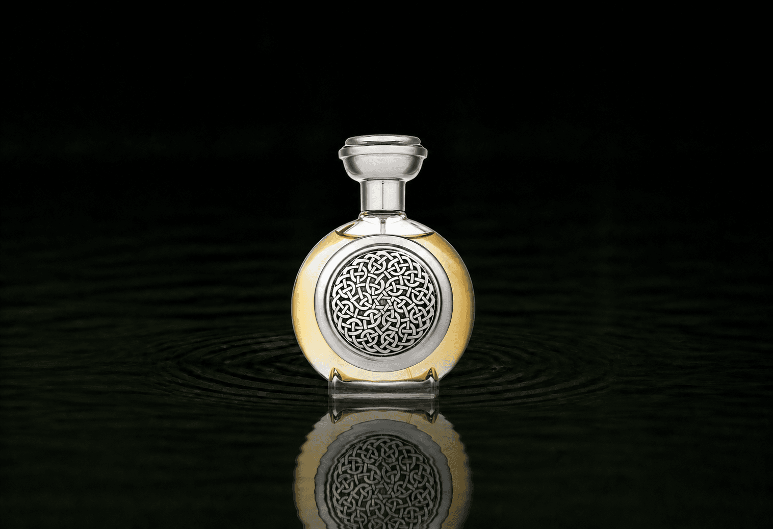 Boadicea The Victorious Bodacious fragrance bottle floating above dark water