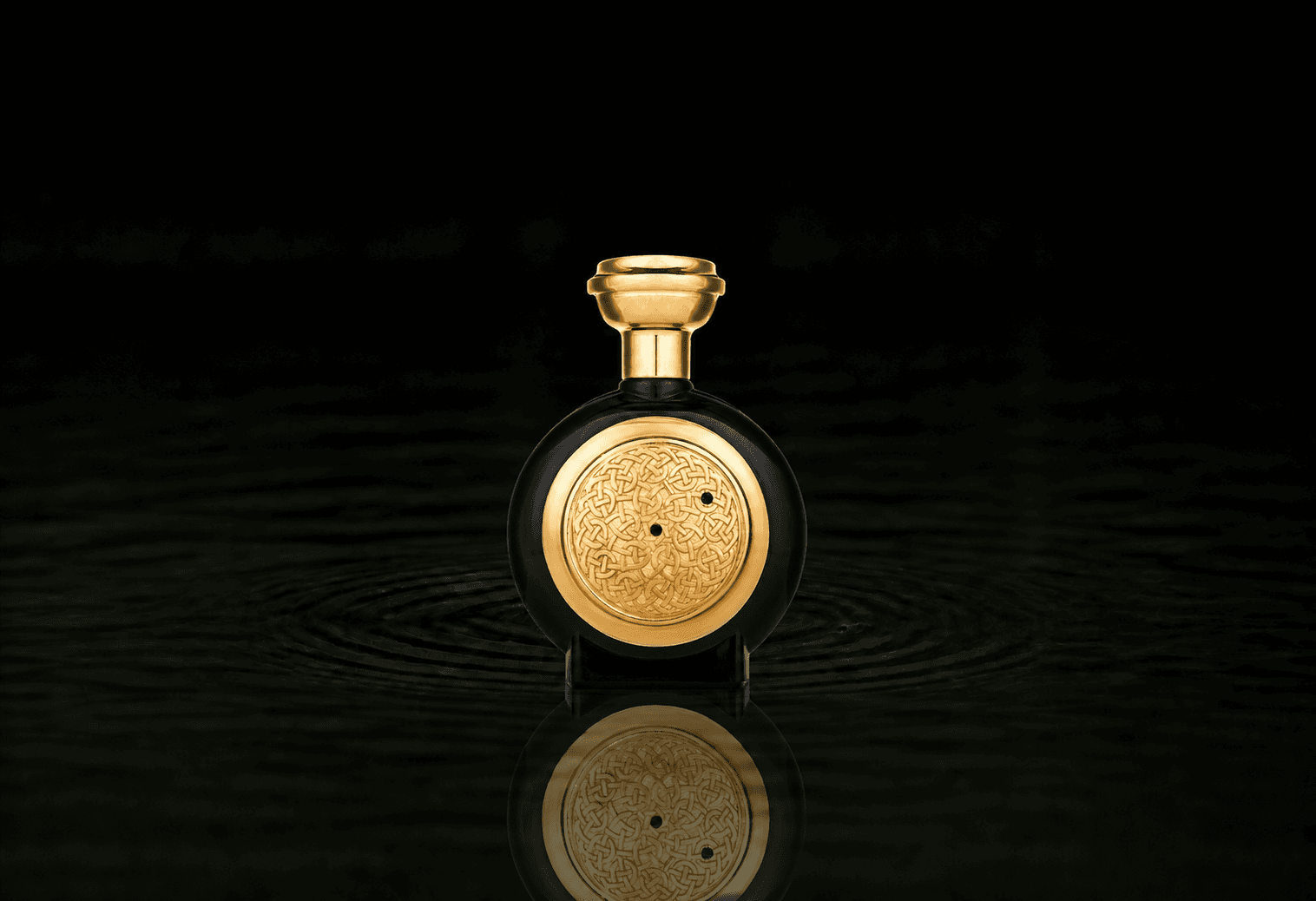 Boadicea The Victorious Carbon Sapphire Supercharged fragrance bottle floating above dark water