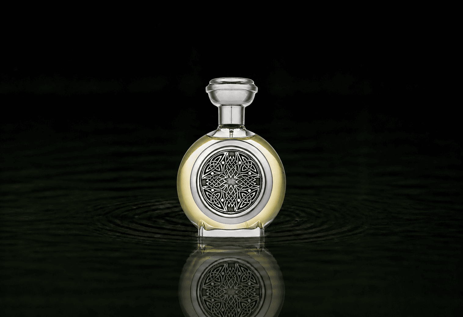 Boadicea The Victorious Envious fragrance bottle floating above dark water