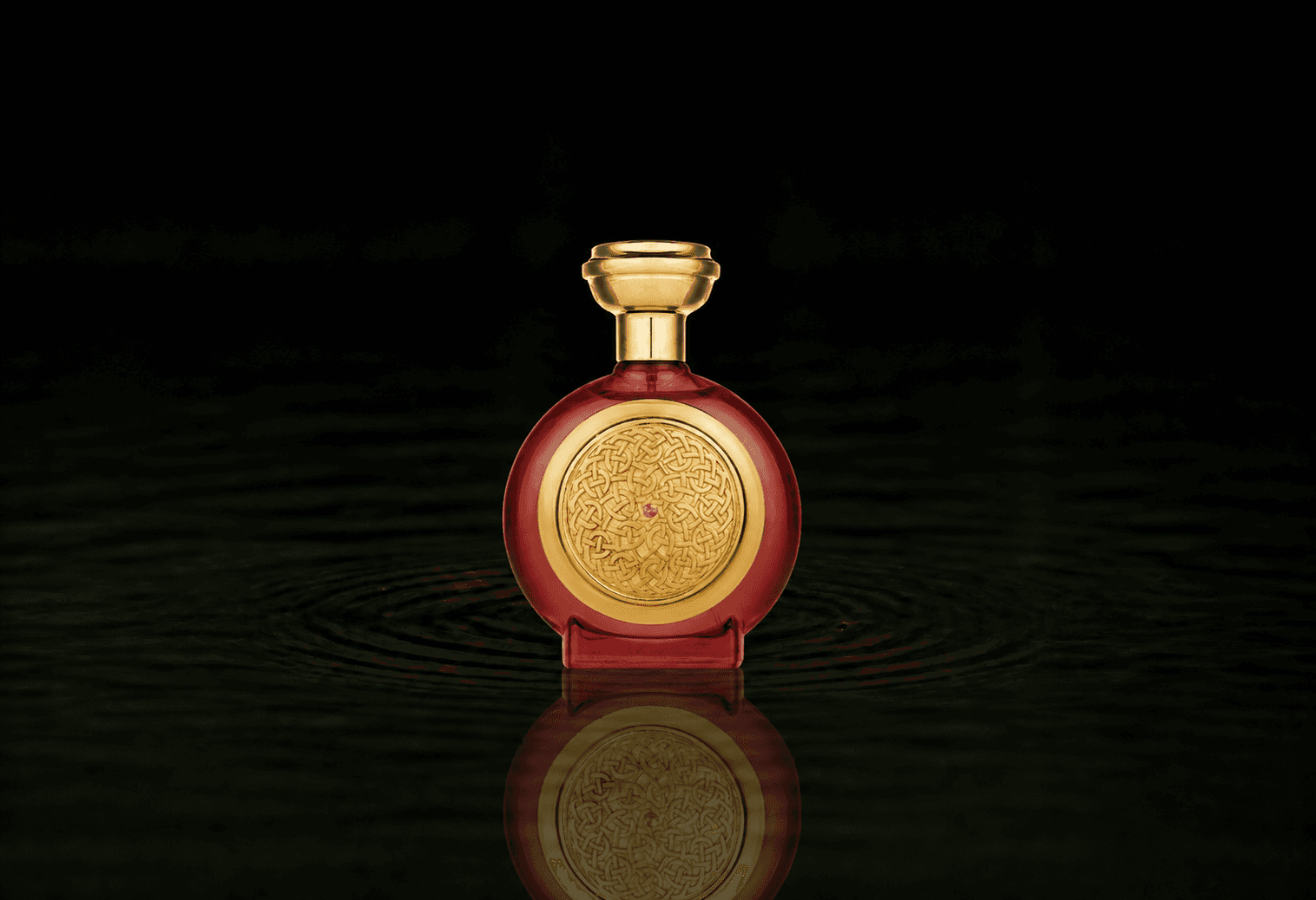 Boadicea The Victorious Oud Sapphire fragrance bottle floating above dark water