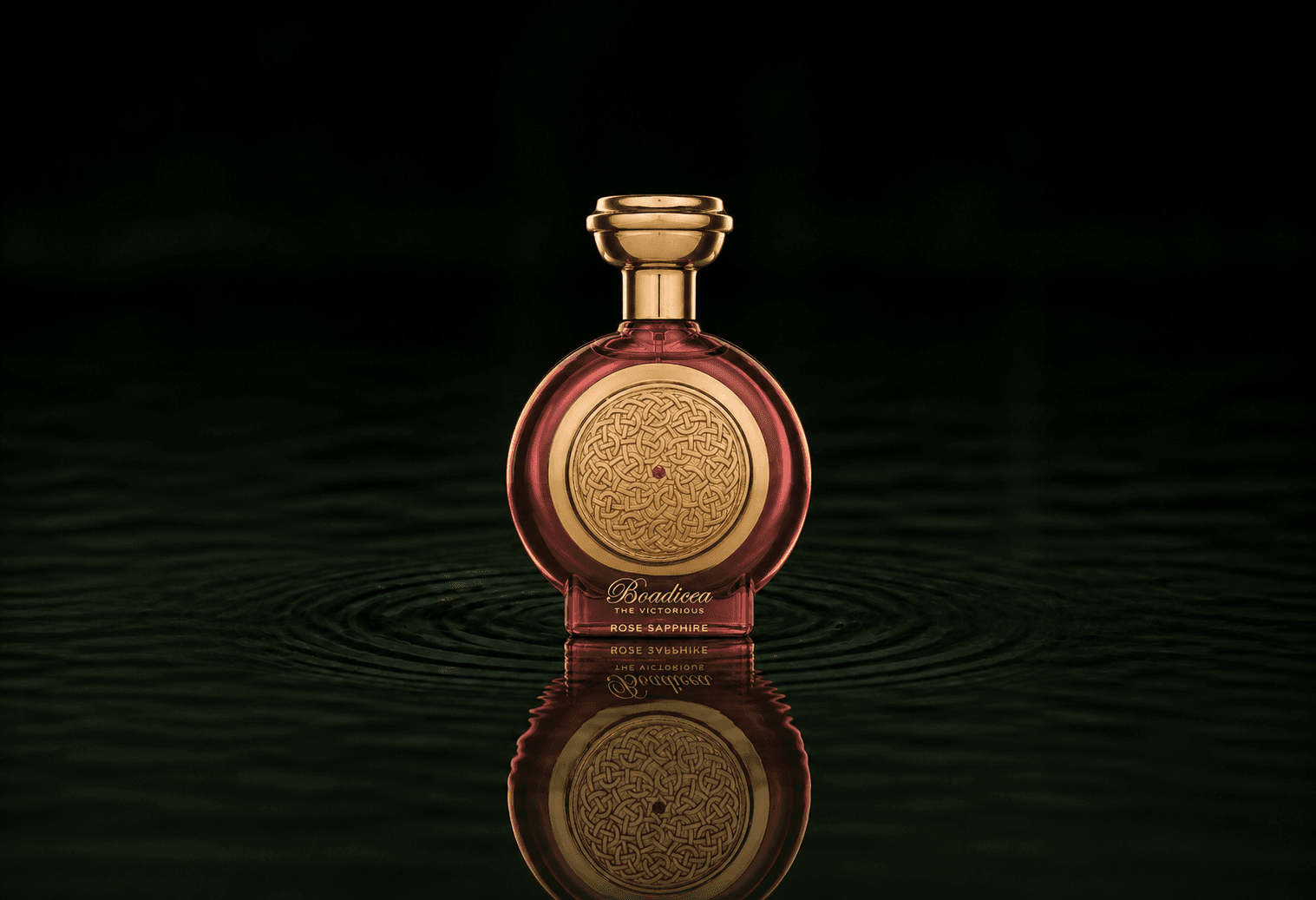 Boadicea The Victorious Rose Sapphire fragrance bottle floating above dark water